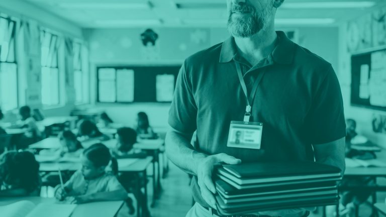 photo of district member passing out tablets to class room