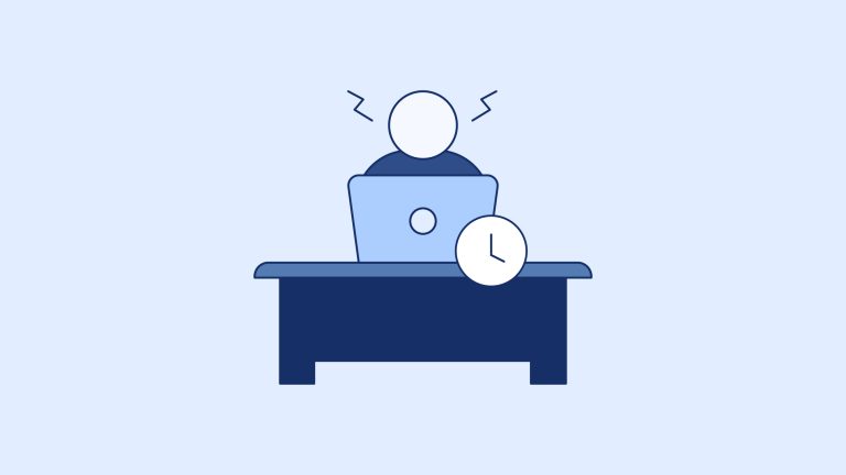 IT professional working at a laptop under pressure during the K–12 back-to-school season