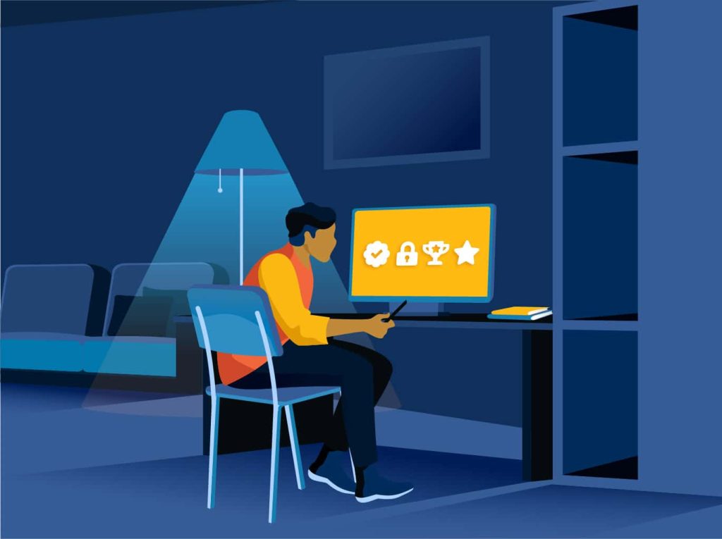 A man sits in his home office, studying on his computer.